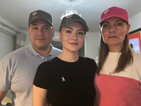 Tianna and her parents wearing hats