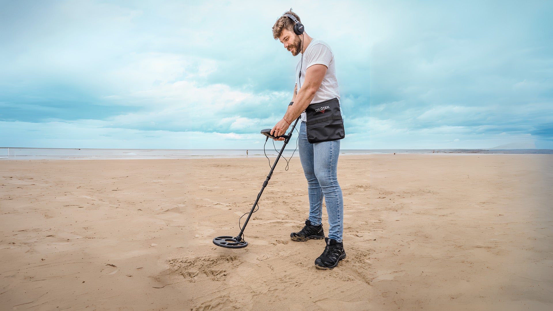 Using a metal detector on the sandy beach