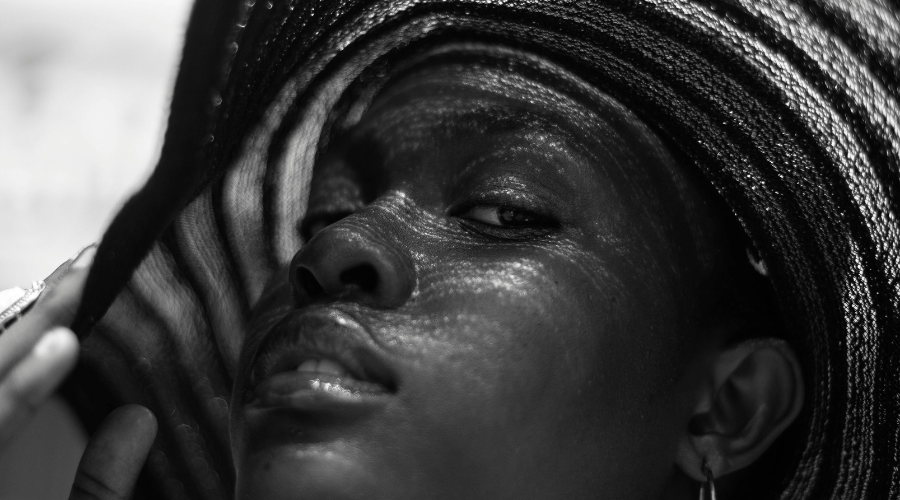 black and white photo of woman wearing sun hat