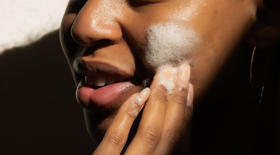 Woman washing her face with African black soap face wash