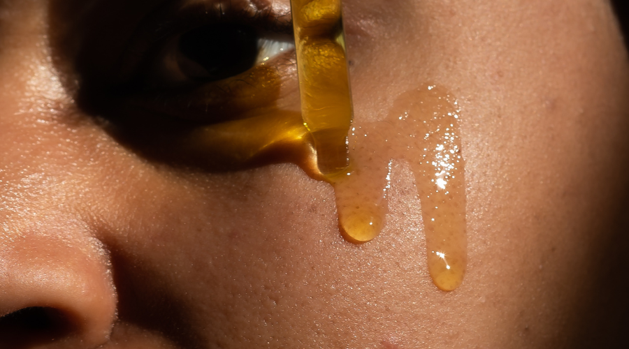 Woman applying Facial Oil on Face