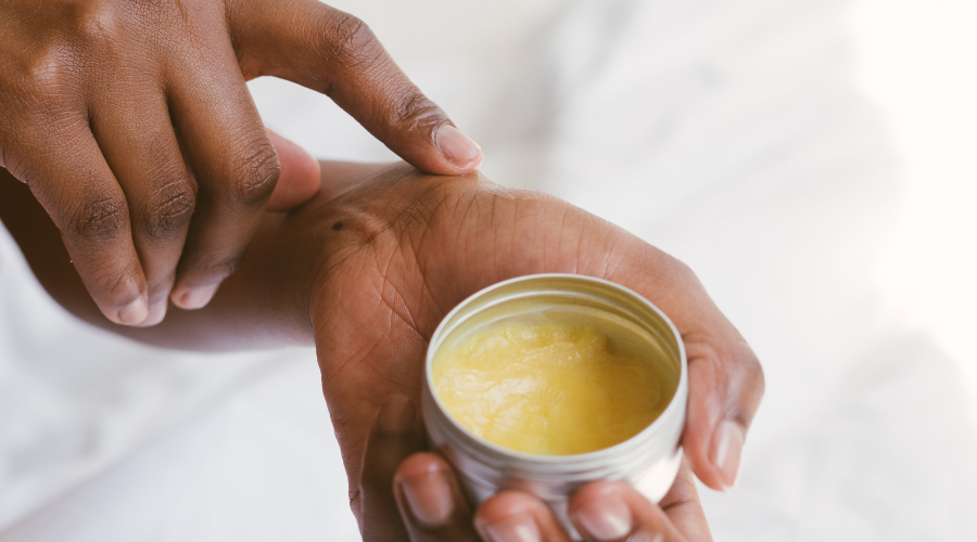 woman putting shea butter on skin