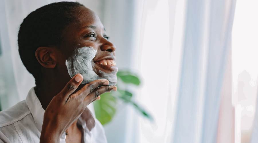 woman shaving her face