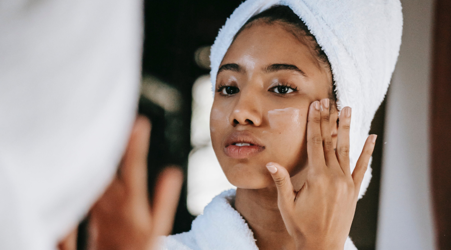 woman giving herself an at-home sugar scrub facial