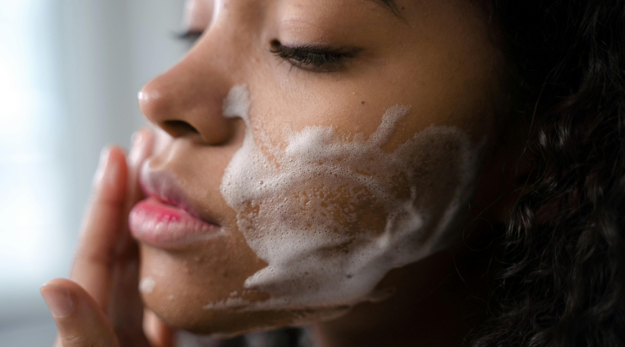 woman cleansing her face