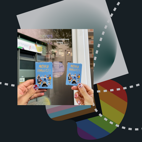 Photo of two hands holding Merry Families games in front of a photoshopped background of two rainbow family centres. Other blue and green elements, as well as an inclusive pride flag, are layered behind the photo.