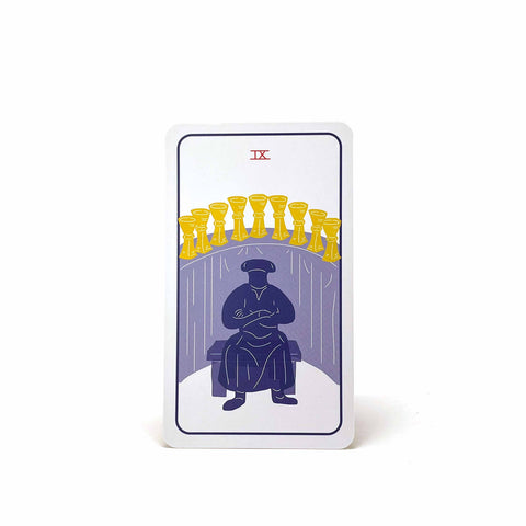 A tarot card with Roman numeral 9, showing a figure sitting in front of a row of nine cups.