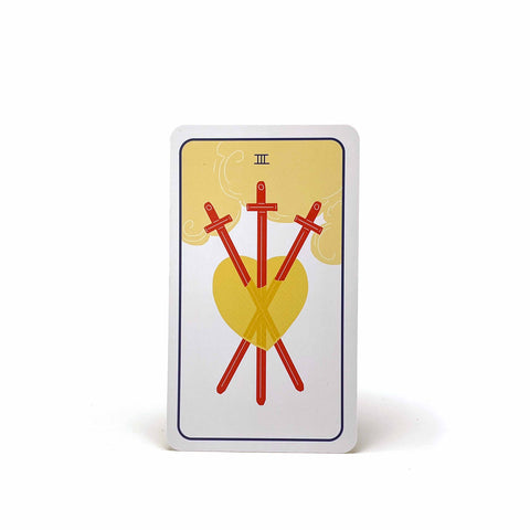 A tarot card with a roman numeral 3, showing a heart with three swords through it.