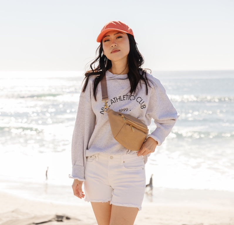 woman wearing a Fawn Design fanny pack at the beach