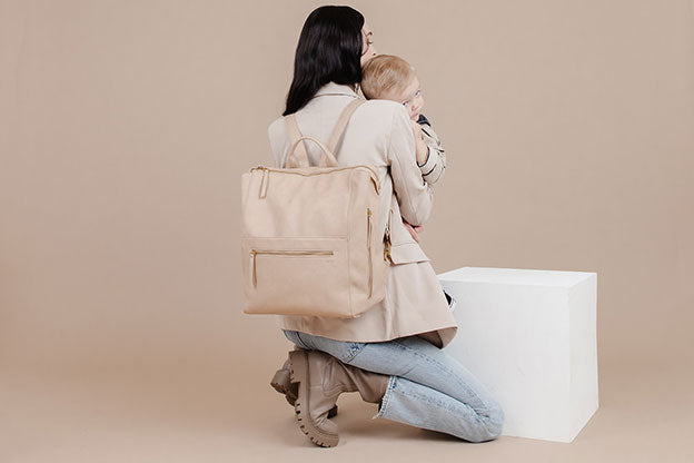 Stylish diaper bag being worn.