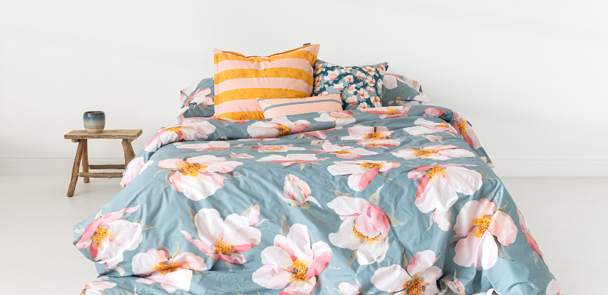 Visión general de cama con funda nórdica  con flores sobre fondo azul