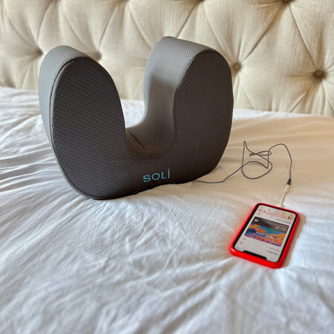 Soli pillow connected to an iPhone with cable and adapter