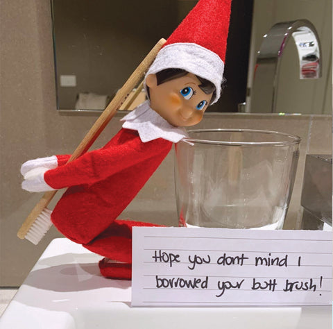 Elf cleaning bottom with toothbrush