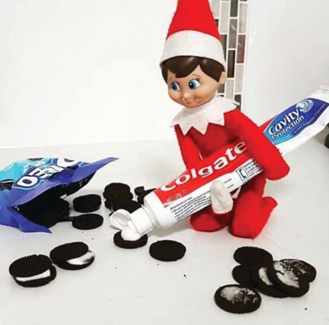 Elf adding toothpaste to cookies