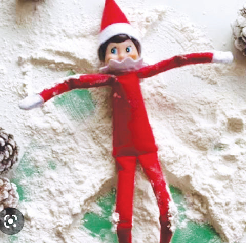 Elf making snow angel from flour