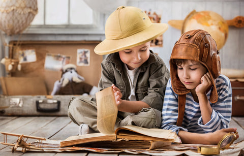 Children in costume reading adventure book