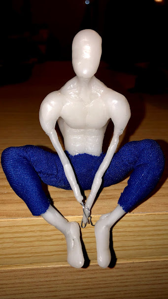 Sitting figure made of InstaMorph wearing blue pants.