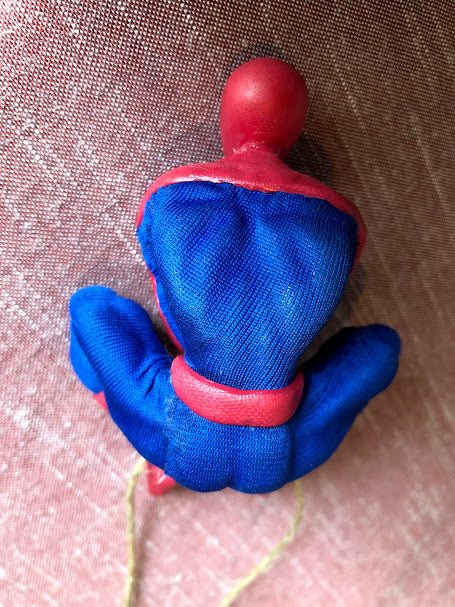 Spider-Man figure made from InstaMorph wearing outfit, sitting, seen from the back.