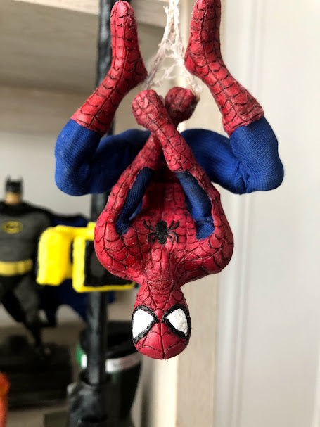 Spider-Man made with InstaMorph in full costume hanging upside down by his webbing.