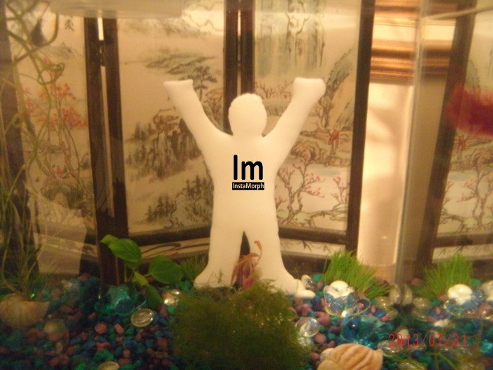 Car antenna decoration in the shape of a person made with InstaMorph moldable plastic shown on a table with decorations.