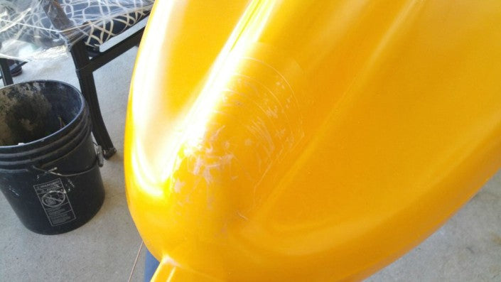 Close up of the kayak hull that is being prepared for InstaMorph moldable plastic hull protector.