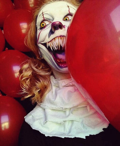 Pennywise costume with red balloons showing costume teeth made with InstaMorph moldable plastic.