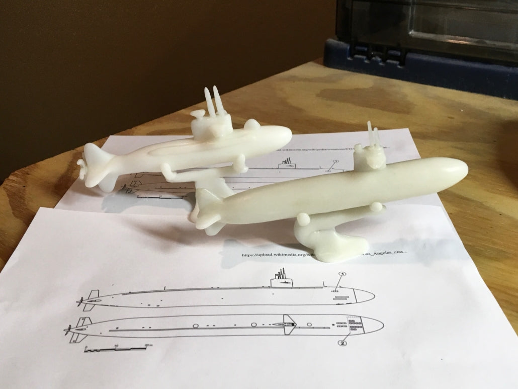 Two submarines that fit on an 8 by 10 piece of paper made out of InstaMorph. Also showing is the drawing of the submarine dimensions.