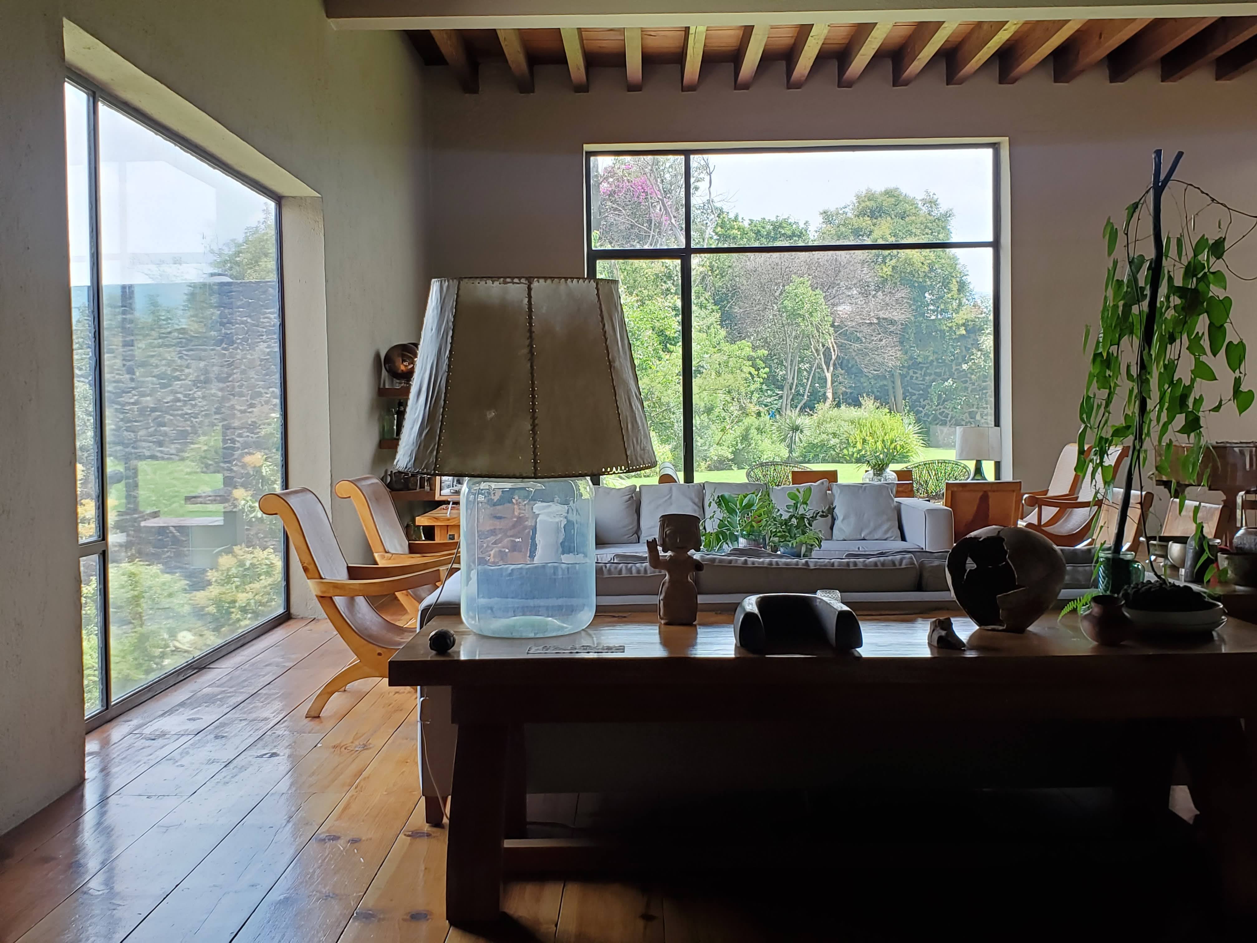 Living room with large glass lamp at Casa Pedregal designed by Luis Barragán in Mexico City.