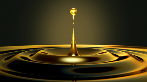 Beard oil droplet landing in pool of beard oil.