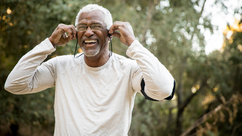 An older man smiling with a goatee.