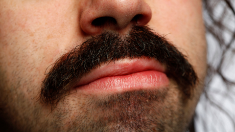 Close up of a man with a beardstache.