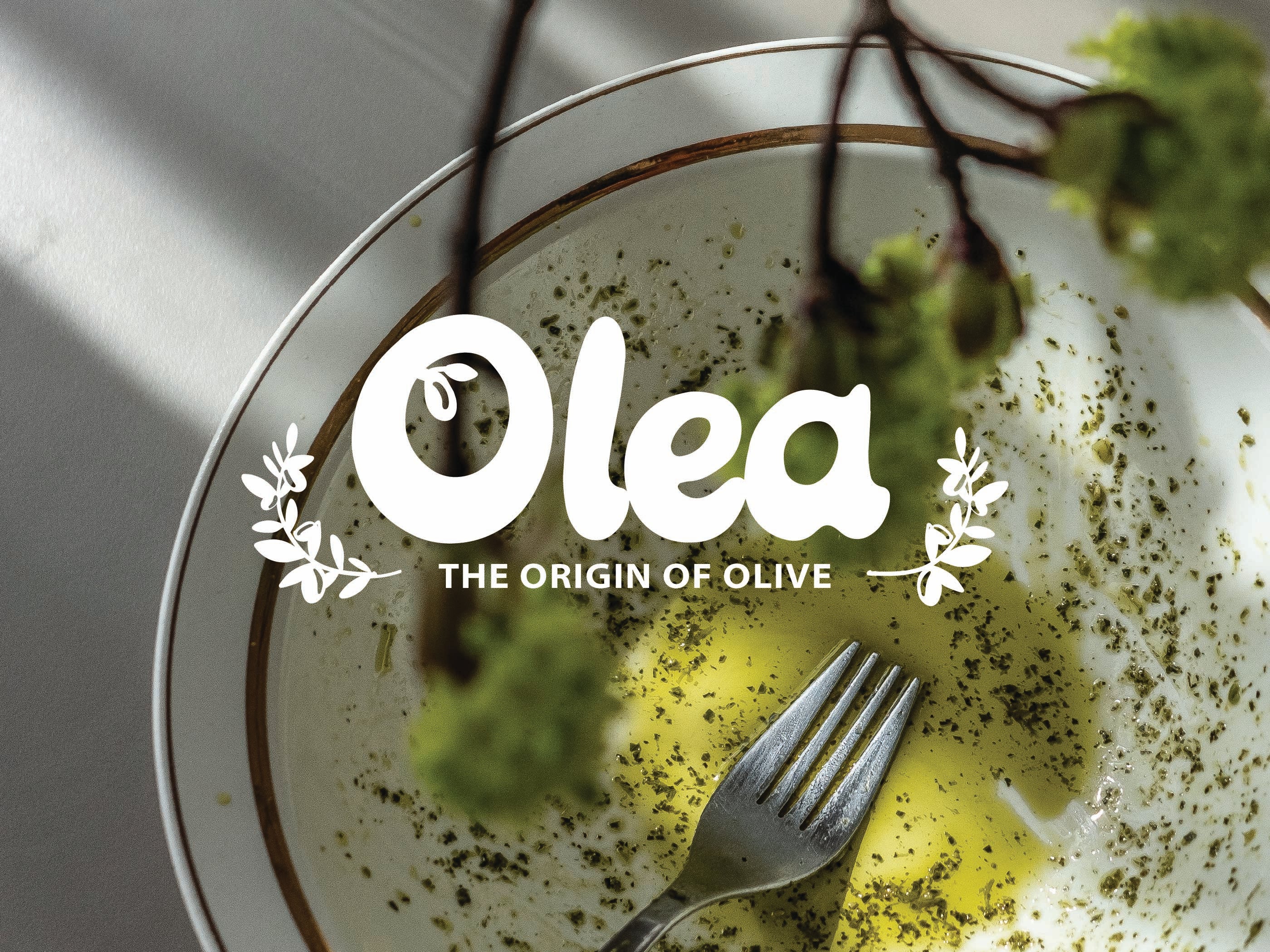 An empty pasta bowl with the Olea logo