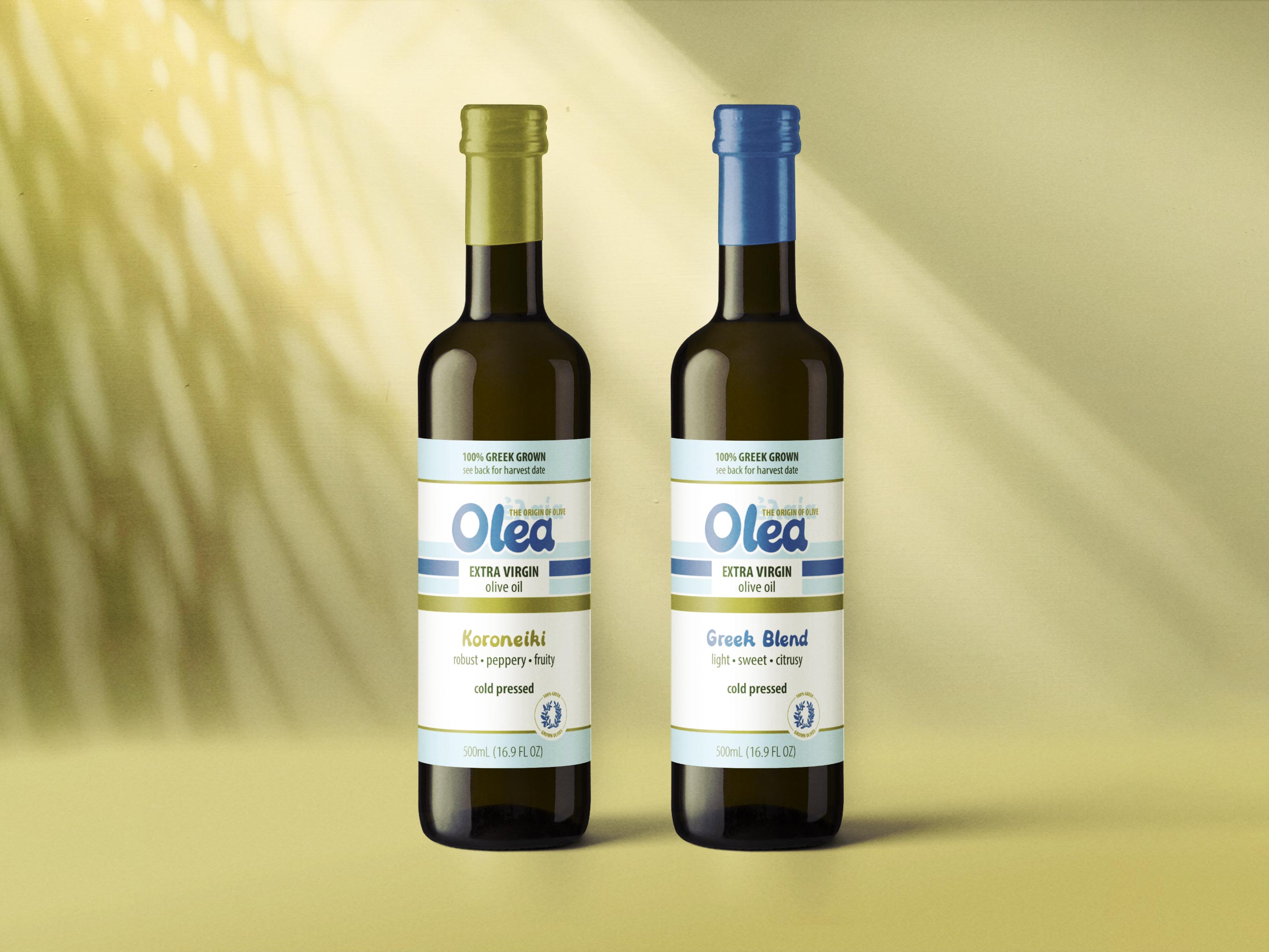 Two olive oil bottles with a white, blue, and gold label design
