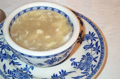 The name is the same as the famous Egg Drop Soup that you find in Chinese restaurants. However, this dish doesn't taste anything like it.  Made of boiling water and eggs. If they have vegetables available, they would add those too.