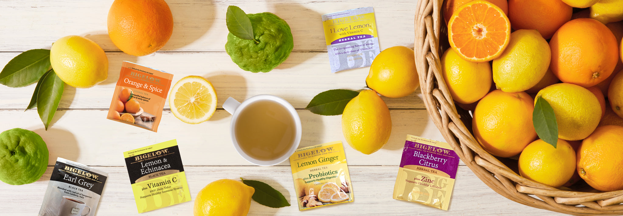 Bigelow Teas that contain citrus and a bowl of citrus fruits