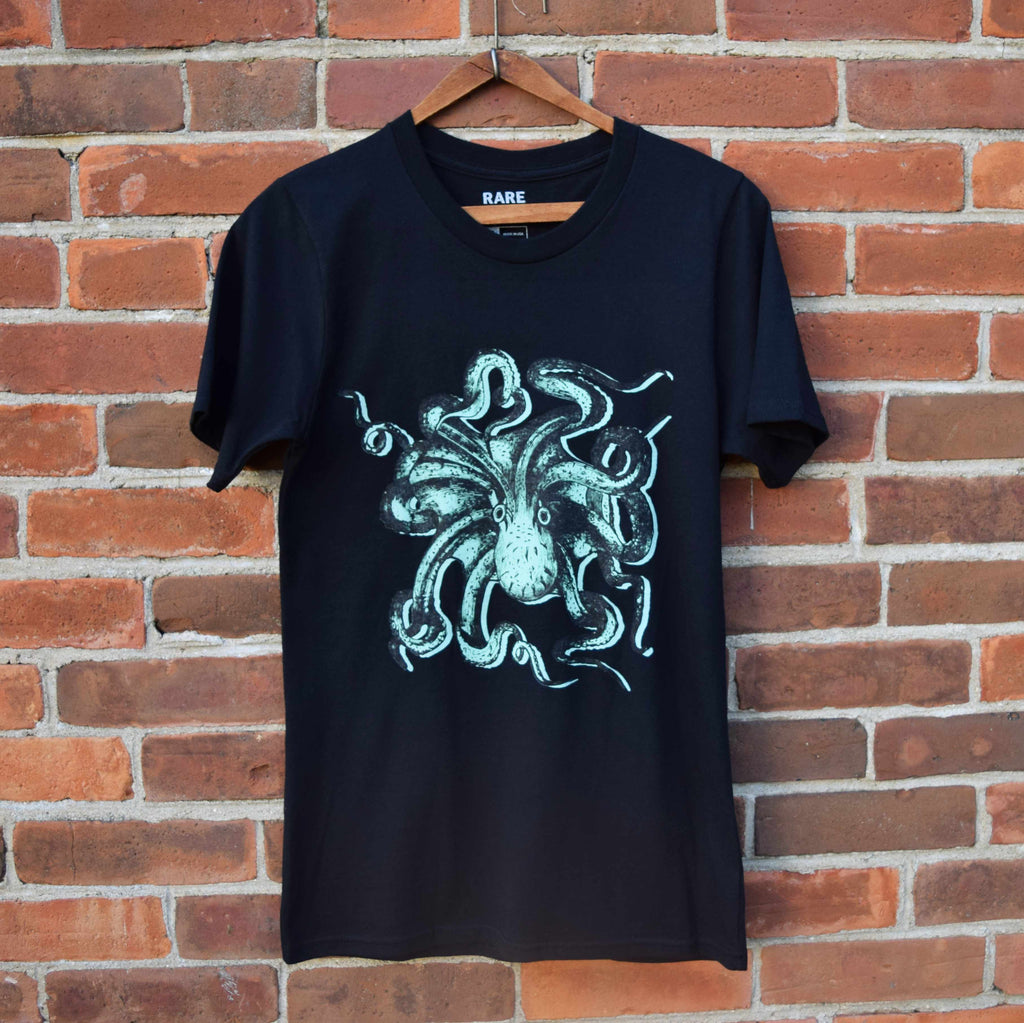The Rare Breed Octopus T-shirt in 100% Organic Cotton features a teal and black octopus line drawing on a black unisex organic t-shirt..