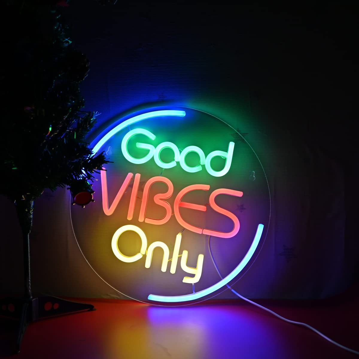 A colorful neon sign “Good Vibes Only”