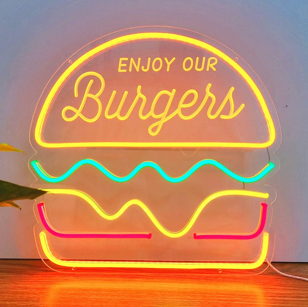 A neon sign advertising a delicious burger