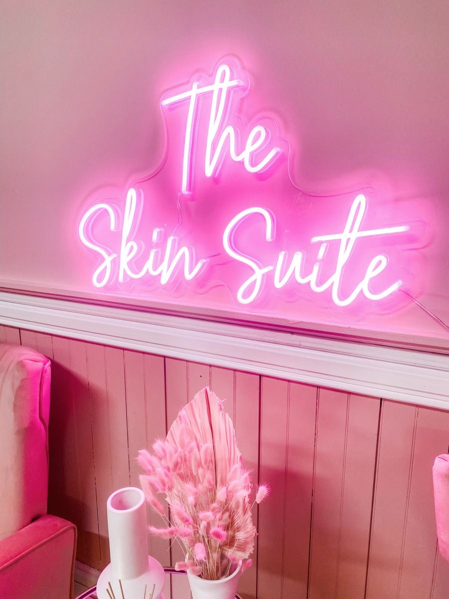 The radiant pink neon light creates a cute overall look for salon