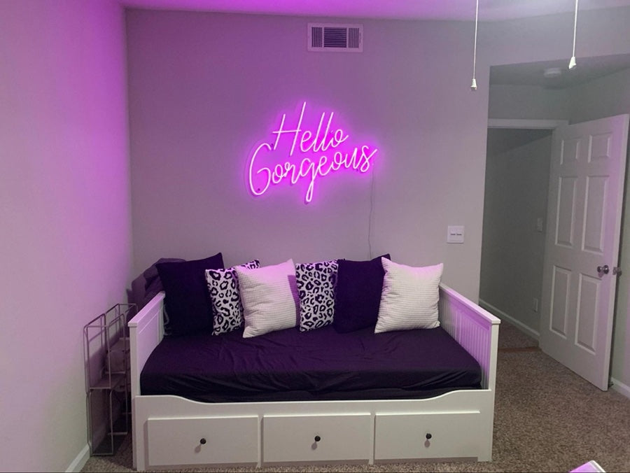 Hanging the Hello Gorgeous LED Neon Sign above the living room sofa