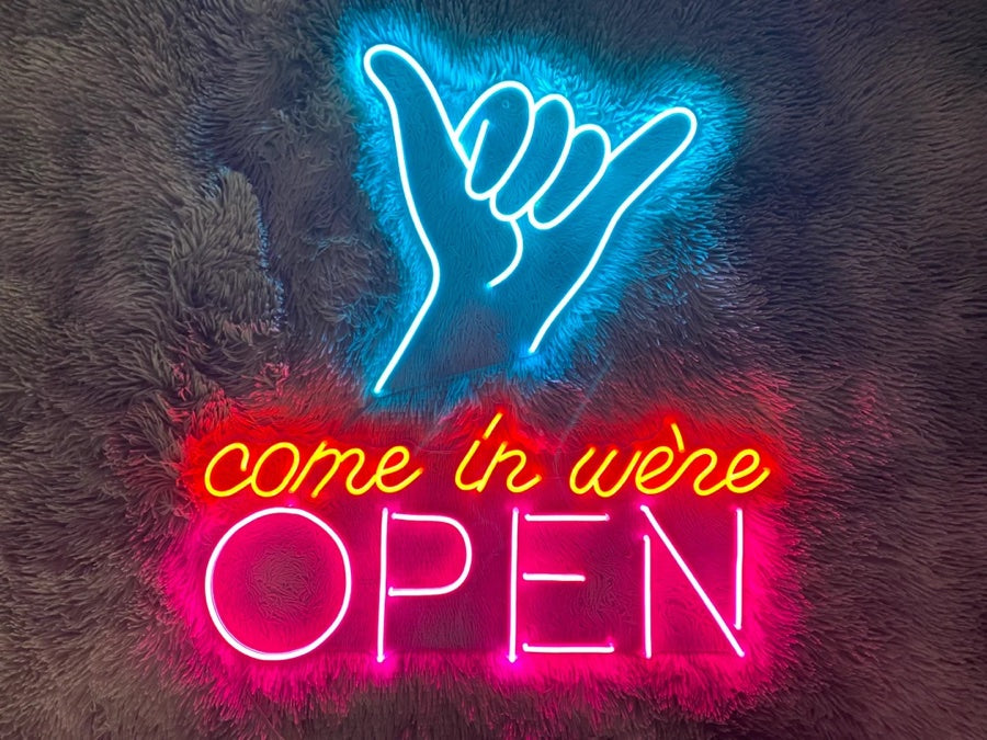 Open neon signs are a trendy and unique way to light up any room