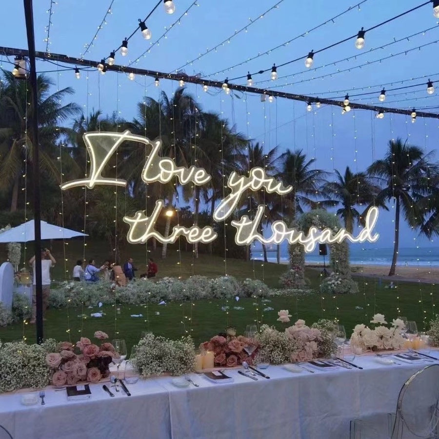 I Love You Three Thousand neon sign at the beach wedding party