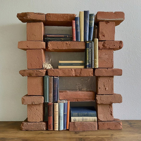 red bricks used to make a bookshelf to stack books
