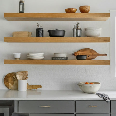 a wooden finish floating shelf in the kitchen