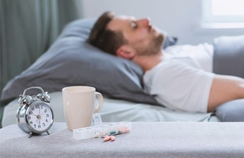 Man taking sleep supplements before bed