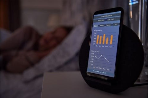 Using sleep tracking app while woman is sleeping