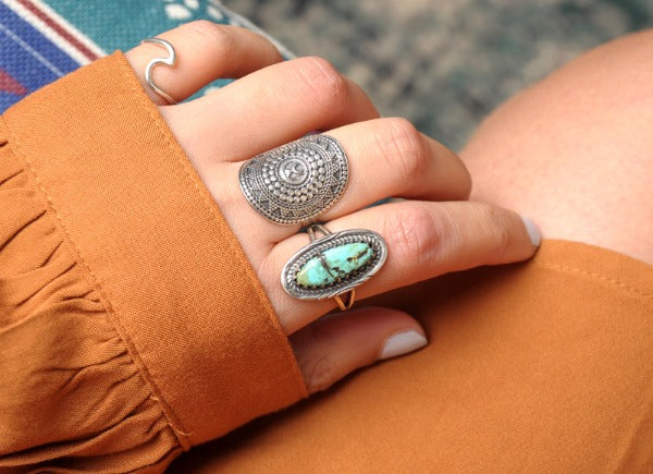 multi sterling silver rings on a hand