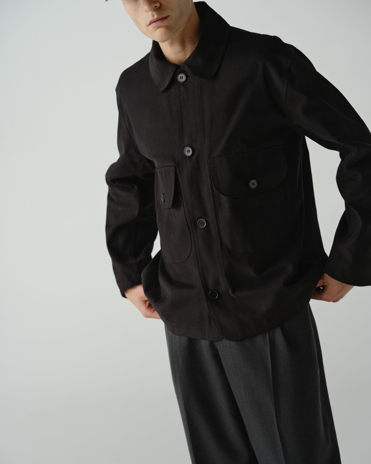 Close up of male model wearing the big pocket jacket in black