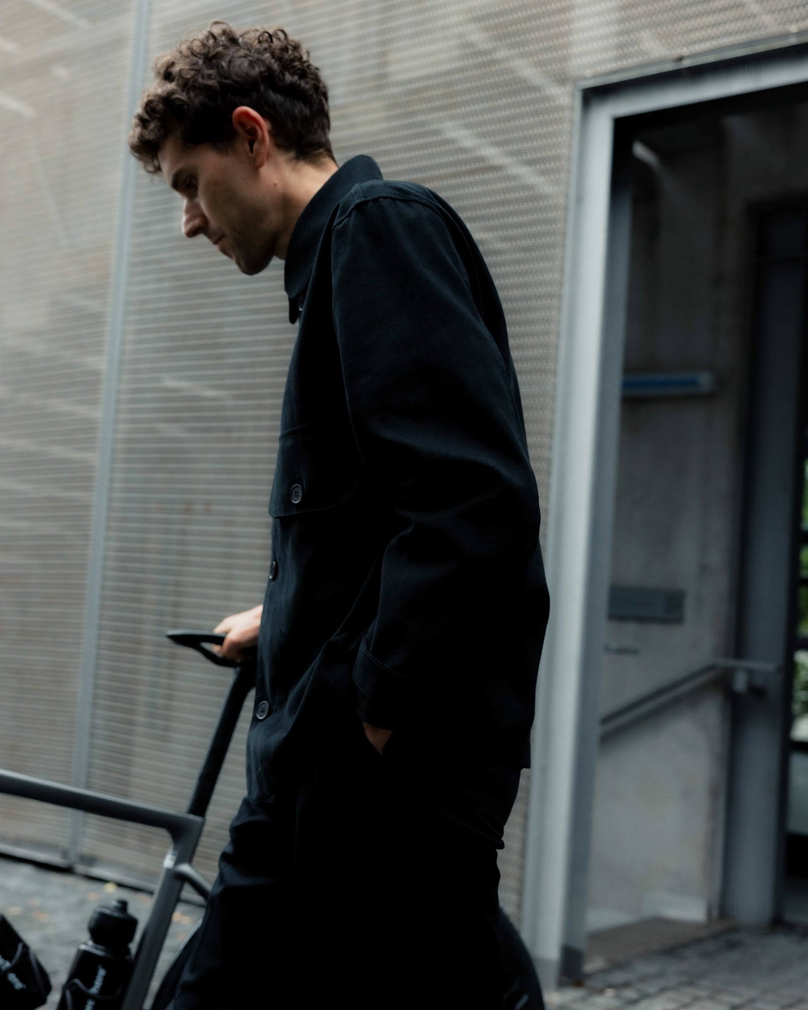 Side view of Johnny wearing the Big Pocket Jacket in black.