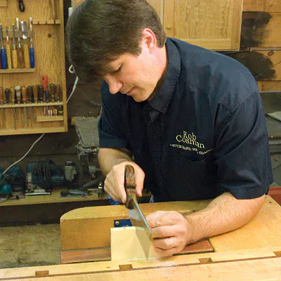 Rob Cosman cutting a dovetail joint by hand, demonstrating traditional woodworking techniques taught in therapeutic woodworking programs like the Purple Heart Project.